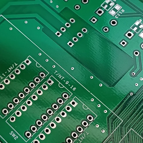 Plated through-hole PCB with visible copper-plated barrels connecting multiple layers